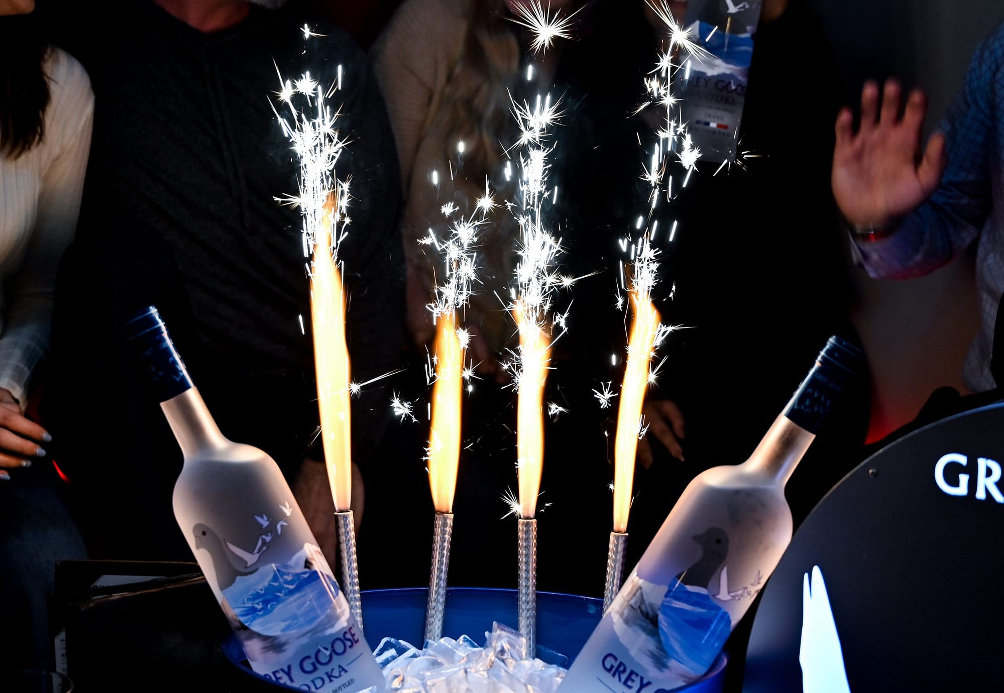 Sparklers in a bucket of ice with two Grey Goose bottles of vodka on either side at Crafty Squirrel in Downtown, St. Petersburg, FL
